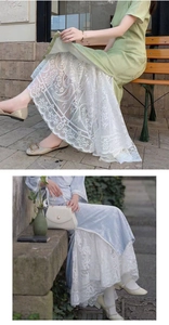 Detail of elegant layered skirt with floral lace embroidery in soft mint and blue hues