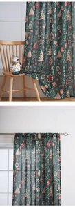 Detailed view of semi-transparent green Christmas curtains with festive snowflake patterns