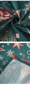 Macro detail of dark green Christmas curtain fabric with white snowflake and red star patterns