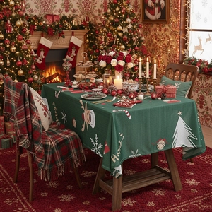 Green Christmas tablecloth with reindeer and snowflake prints for holiday festive dining decor