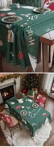 Detailed texture of dark green Christmas tablecloth with reindeer and snowman patterns