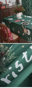 Macro detail of Christmas green tablecloth showing woven texture and festive elk patterns