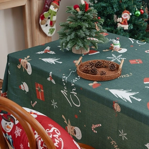 Deep green Christmas tablecloth with reindeer and snowman prints for festive dining decor