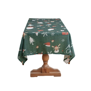 Green Christmas tablecloth with festive elk and Santa patterns for holiday table decor