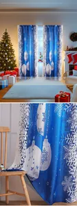 Detailed close-up of blue Christmas curtain fabric with white snowflake and ornament prints