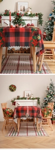 Detail of red and black checkered Christmas tablecloth with floral festive pattern edges