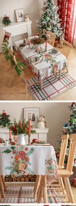 Detail of Christmas tablecloth with scalloped edges featuring festive bells and candy prints
