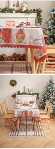 Detail of Christmas tablecloth with snowman pattern and red wavy scalloped edge design