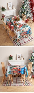 Close-up of festive Christmas tablecloth with Santa and reindeer pattern on thick fabric