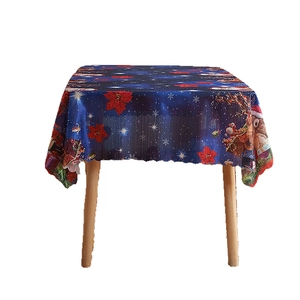 Christmas tablecloth featuring Santa, reindeer and snowflakes on a dark blue night sky pattern