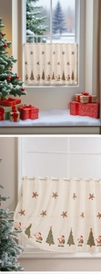 Close-up of Christmas lace cafe curtain with Santa Claus and tree embroidery details