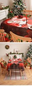 Detailed view of Santa Claus print on red Christmas tablecloth with scalloped edges