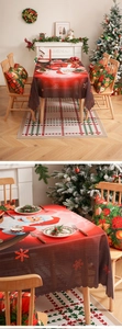 Detail of red mesh tablecloth with festive Santa Claus print and wavy scalloped edges