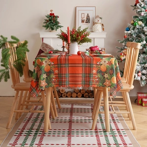 Christmas plaid tablecloth with pine needles and festive holiday ornaments decor
