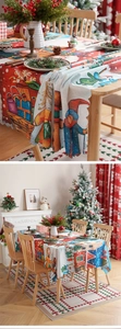 Detail of scalloped edge Christmas tablecloth with gnome and snow house print