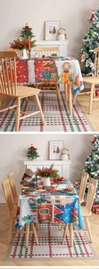 Close-up of Christmas tablecloth and floor mat with festive snowy house illustrations