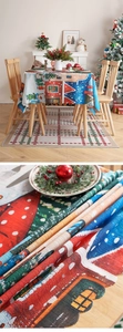 Detail of Christmas tablecloth fabric texture with festive house print and wavy edges