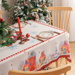 Christmas tablecloth with Santa patterns and laser-cut wavy edges on a dining table
