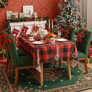 Christmas buffalo plaid tablecloth with red floral prints in festive dining room setting