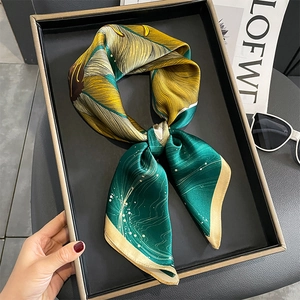 Elegant silk square scarf featuring vintage green and yellow leaf patterns on black tray