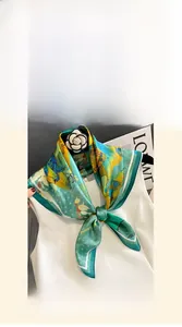 Close-up of 70cm silk scarf showing glossy texture and blue green abstract pattern