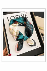 Detailed view of silk square scarf featuring vintage floral print and pink hemmed edges