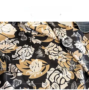 Macro detail of imitation silk scarf featuring vintage floral and butterfly prints