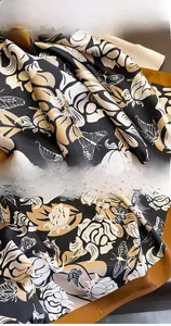 Detailed view of floral silk scarf featuring eco-friendly dyeing and precise stitching