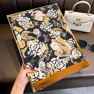 Fashionable long faux silk scarf with black and gold floral rose and butterfly print