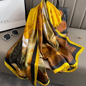 Elegant silk-like floral scarf with butterfly patterns and ginger yellow border stripes