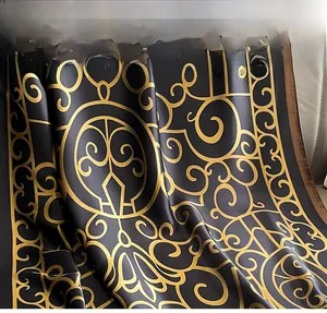 Detail of faux silk scarf with gold vintage scroll patterns and eco-friendly dyeing