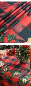 Close-up of red and black plaid Christmas tablecloth with poinsettia floral prints