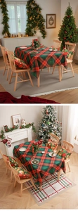Detail of red and green tartan Christmas tablecloth and festive cushions set