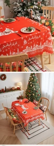 Detail of red Christmas tablecloth with white reindeer motifs and scalloped edges