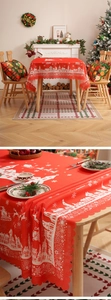 Close-up of red Christmas tablecloth featuring white snowflake prints and scalloped edges