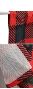 Detail of red and black buffalo plaid kitchen curtain fabric with rod pocket sleeve
