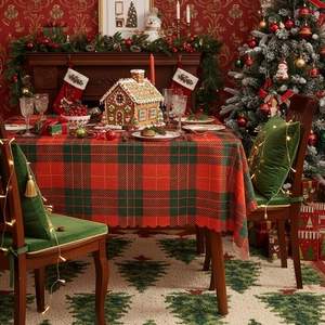Christmas table runner with red green plaid and velvet chair cushion in festive room