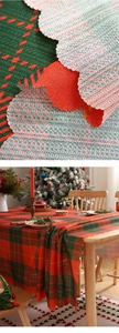 Detail of red and green plaid Christmas tablecloth with decorative scalloped edges