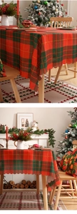 Detail of red and green plaid Christmas tablecloth with scalloped edges for festive decor