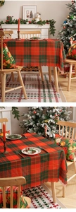 Detailed view of red and green plaid Christmas tablecloth with decorative serrated edges
