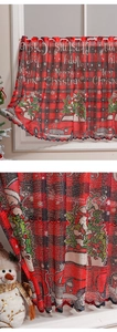 Detail of red black plaid Christmas cafe curtain with Santa and truck prints