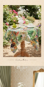 Detailed close-up of oil painting style floral table cover on a round patio table