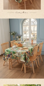 Detailed texture of oil painting floral tablecloth on a vintage wooden dining table