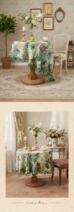 Detail of oil painting floral tablecloth with green ball fringe and retro French charm