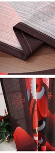 Close-up of festive Christmas curtain fabric showing red snowflake print and white hem stitching