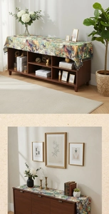 Detail of vintage oil painting floral table runner with elegant fringe tassels on a cabinet