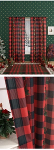 Close-up of red buffalo plaid Christmas curtain fabric with poinsettia and star patterns