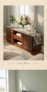 Detail of vintage floral table runner with intricate fringes on a wooden cabinet