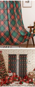 Detail of classic red and green Christmas plaid curtains with elegant holiday drapery