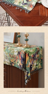 Detail of vintage floral table runner with blue beaded fringe tassels on fabric